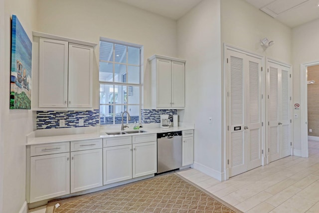 kitchen featuring white cabinetry, sink, backsplash, and dishwasher