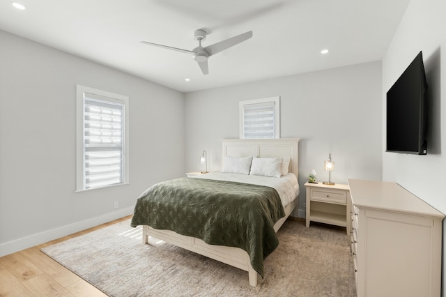 bedroom with light hardwood / wood-style floors and ceiling fan