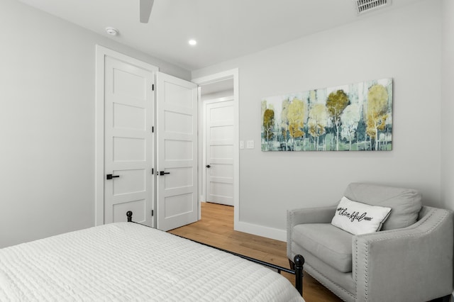 bedroom featuring wood-type flooring and ceiling fan