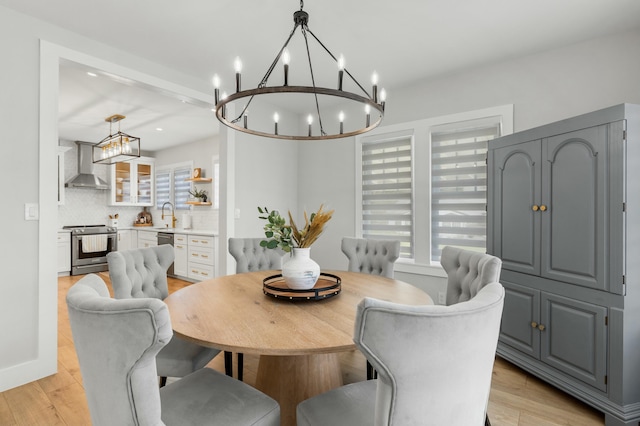 dining area with sink and light hardwood / wood-style flooring