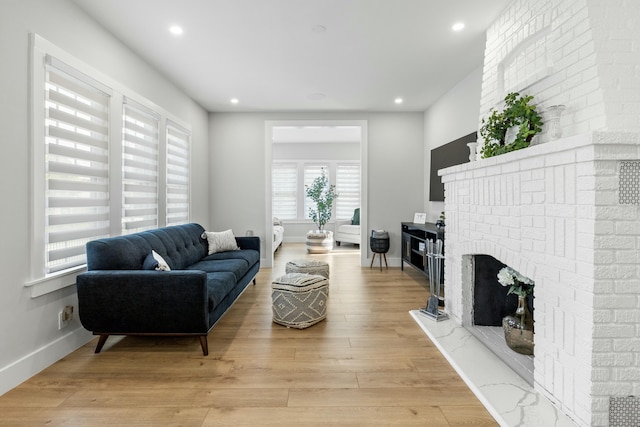 living room featuring a fireplace and light hardwood / wood-style floors