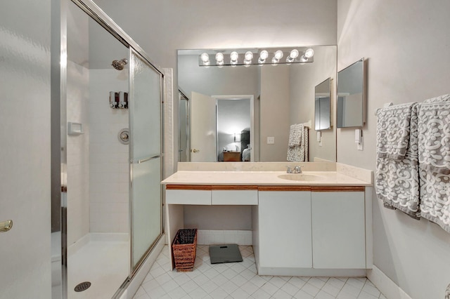 bathroom featuring vanity and a shower with shower door