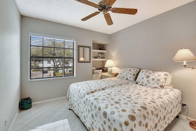 bedroom featuring a textured ceiling and ceiling fan