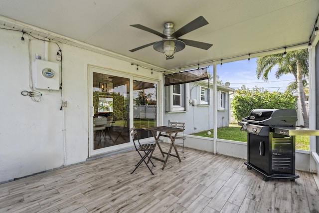 sunroom / solarium featuring plenty of natural light and ceiling fan