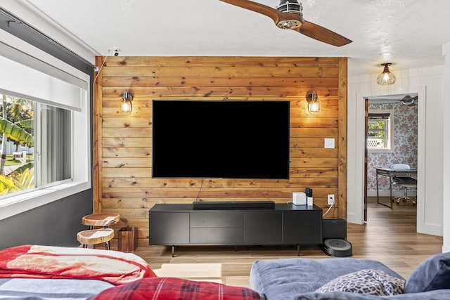 living room with wood-type flooring and ceiling fan