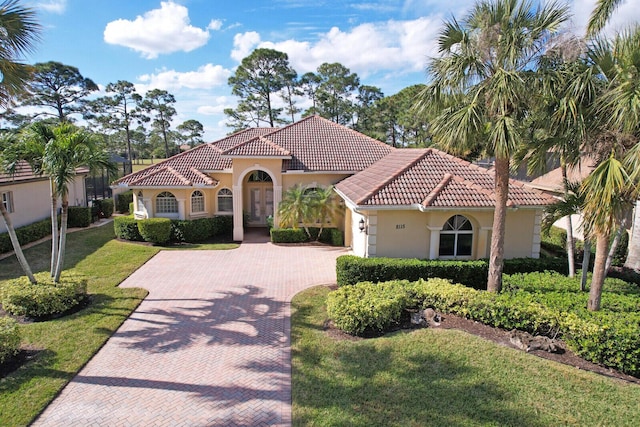 mediterranean / spanish-style house with a front lawn