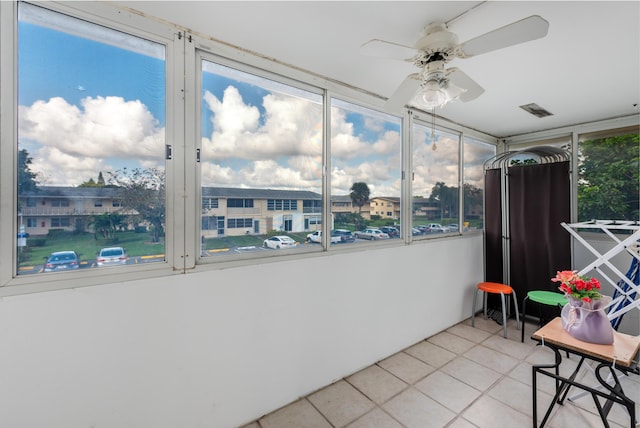 sunroom featuring ceiling fan