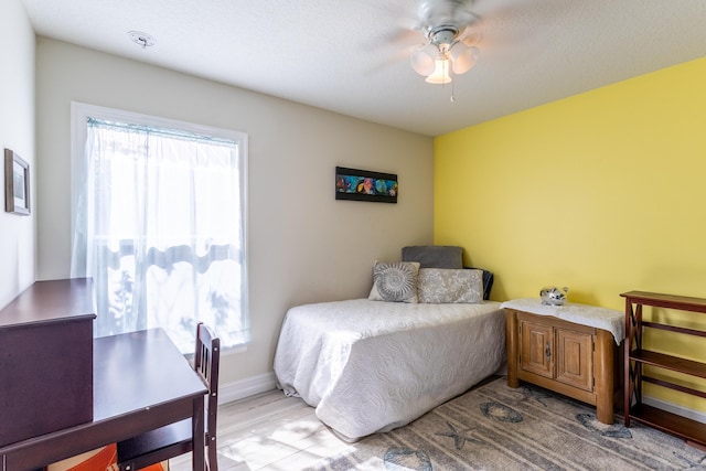 bedroom featuring ceiling fan and light hardwood / wood-style flooring