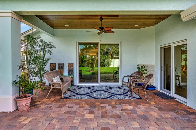 living room with ornamental molding, lofted ceiling, ceiling fan, and light wood-type flooring