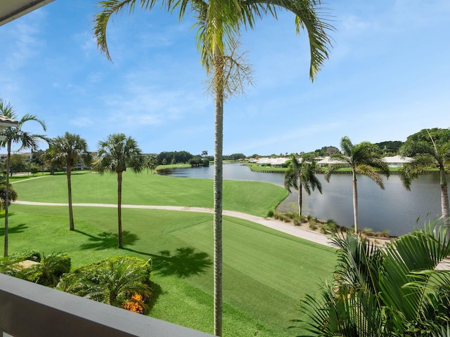 view of home's community featuring a water view and a lawn