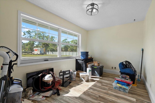 interior space featuring a textured ceiling and light wood-type flooring