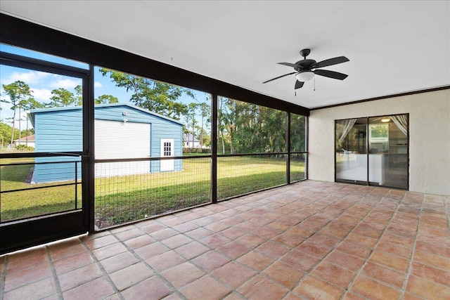 unfurnished sunroom with plenty of natural light and ceiling fan