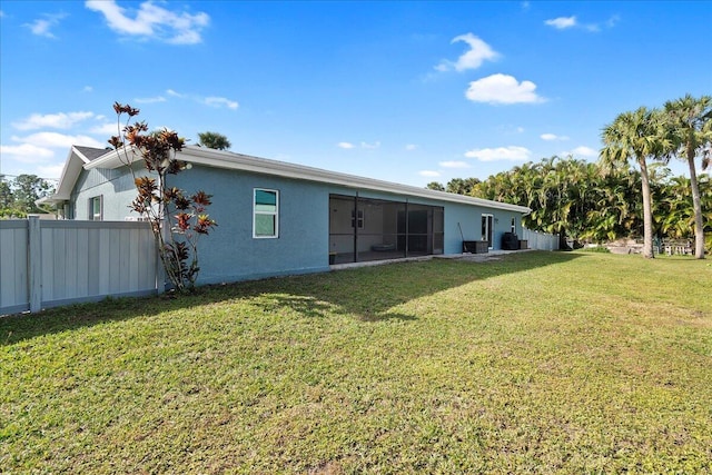 back of house featuring a yard