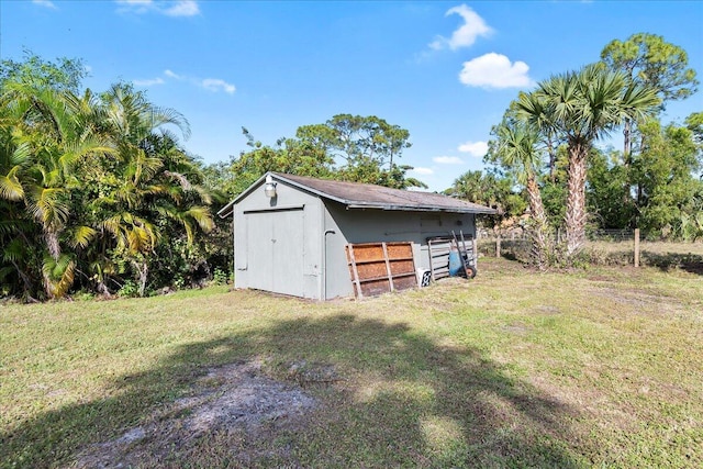 view of outbuilding featuring a yard