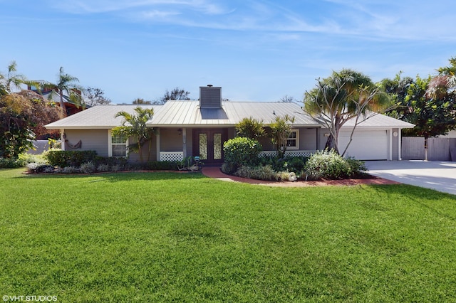 single story home featuring a garage, a front lawn, and french doors