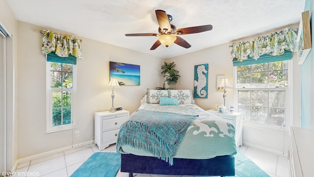 tiled bedroom with ceiling fan