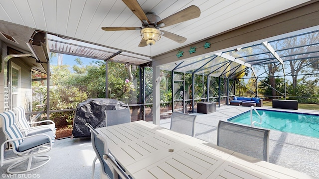 view of swimming pool featuring a grill, an outdoor living space, glass enclosure, and a patio area