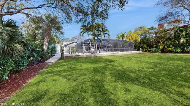 view of yard featuring glass enclosure