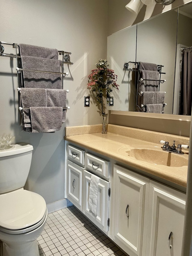 bathroom featuring tile patterned floors, toilet, and vanity