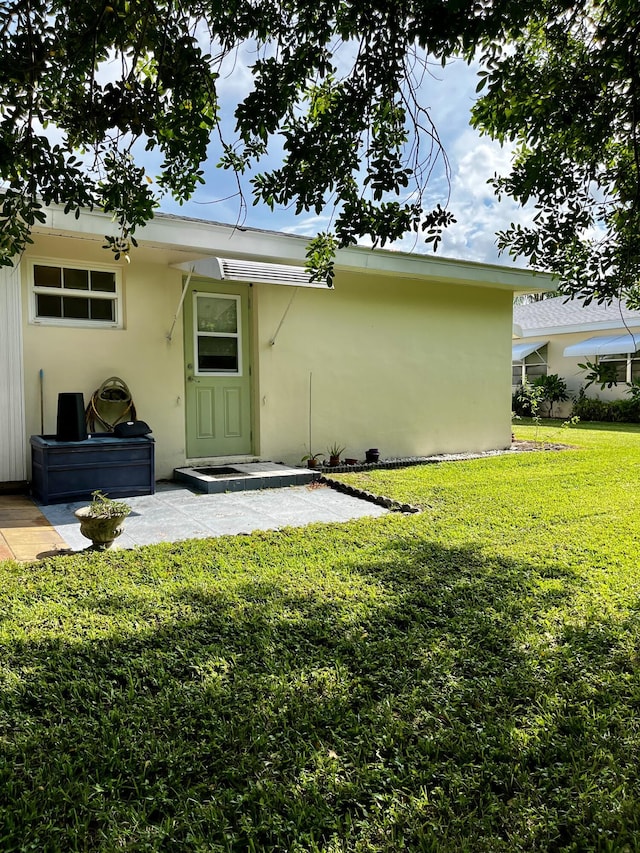 rear view of house featuring a yard