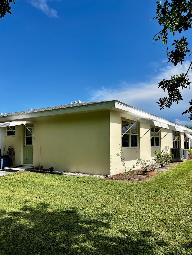 view of home's exterior with a lawn