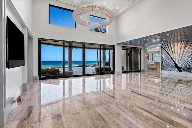 kitchen featuring appliances with stainless steel finishes, light countertops, a kitchen island with sink, and custom range hood