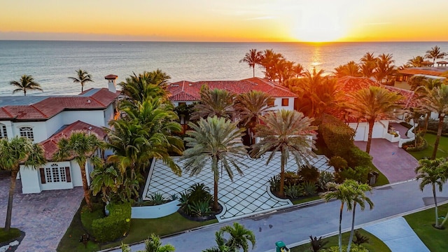 birds eye view of property featuring a water view, a residential view, and a view of the beach