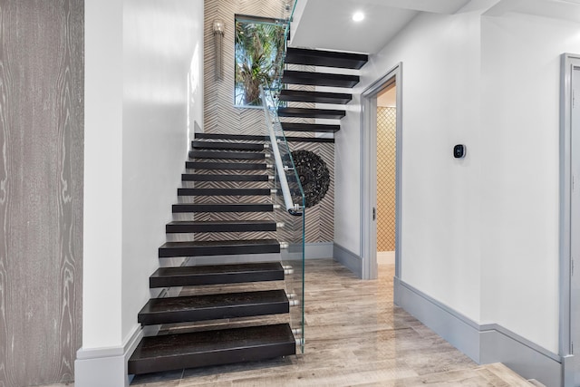 walk in closet featuring dark wood-style floors, lofted ceiling, and an inviting chandelier