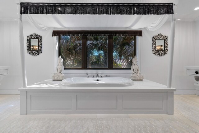 bathroom featuring vanity, baseboards, crown molding, and wood finished floors