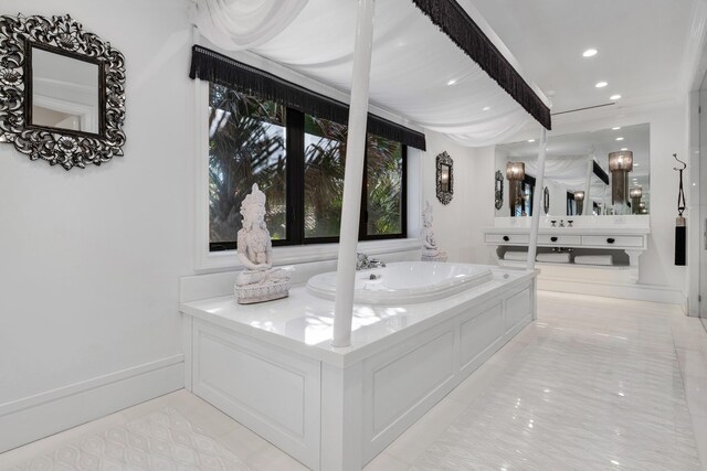 laundry area with washer and dryer, a wainscoted wall, cabinet space, and a sink