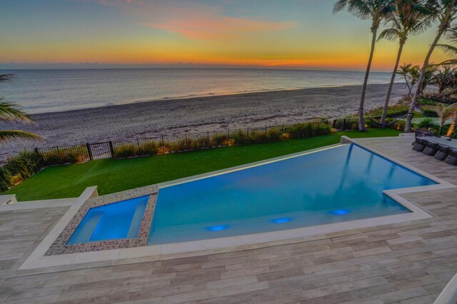 view of patio featuring a fenced in pool, a water view, and ceiling fan