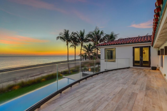 exterior space with a bar, a water view, and a pool