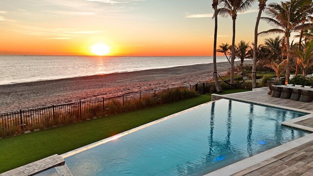 surrounding community featuring a water view and outdoor dining area