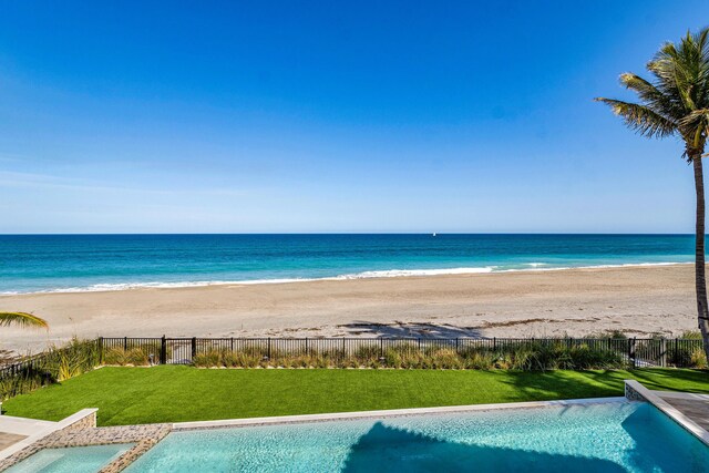 view of patio / terrace with an outdoor kitchen, grilling area, and a water view