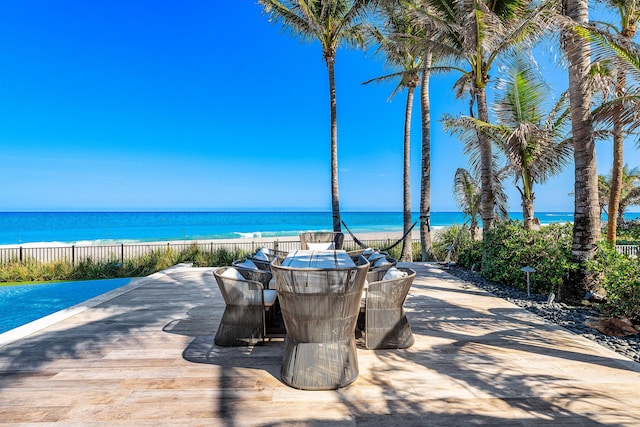 view of home's community with outdoor dining area and a water view