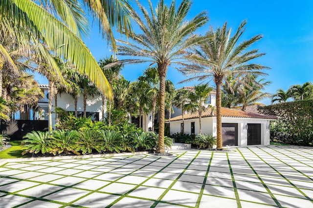 back of house featuring a patio, an outdoor pool, a lawn, and stucco siding