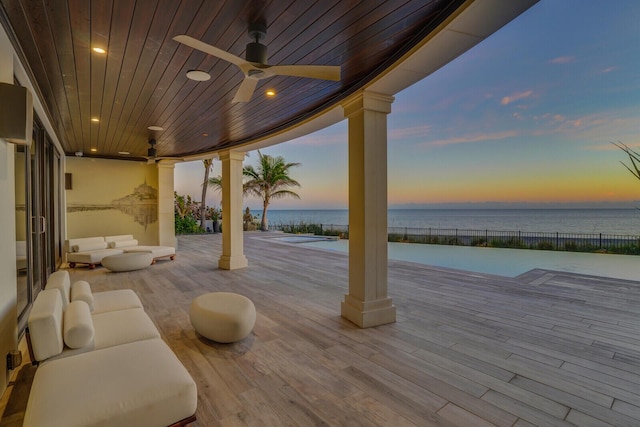 view of patio featuring a ceiling fan and a water view