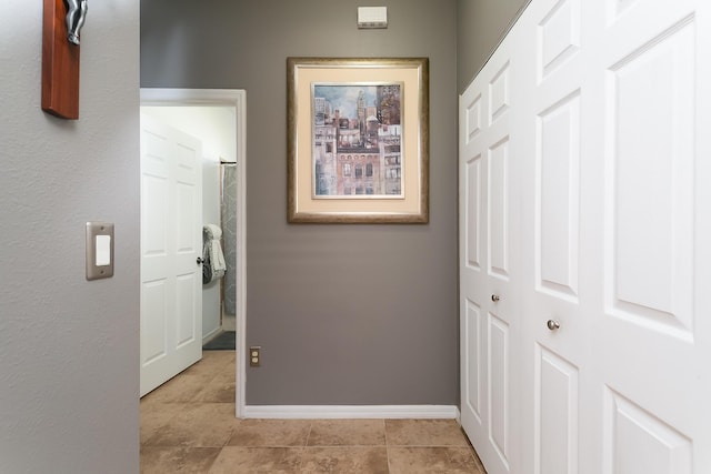 corridor with light tile patterned floors