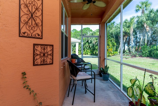 sunroom featuring ceiling fan