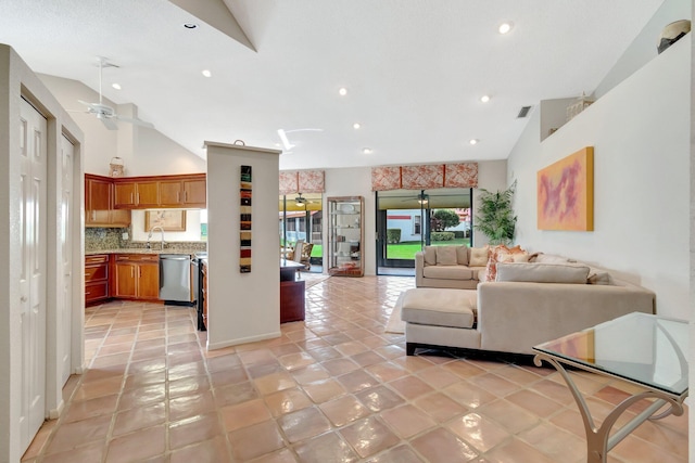 living room with high vaulted ceiling, sink, light tile patterned floors, and ceiling fan