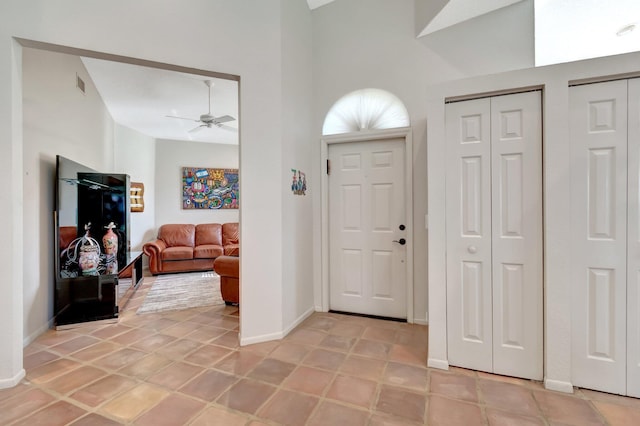 entrance foyer featuring light tile patterned floors and ceiling fan