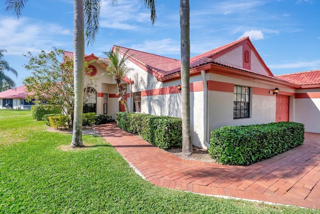 view of property exterior featuring a lawn