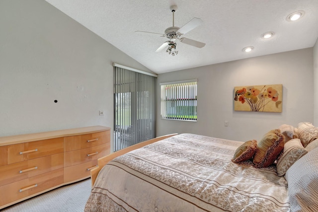 carpeted bedroom with ceiling fan, vaulted ceiling, a textured ceiling, and access to outside