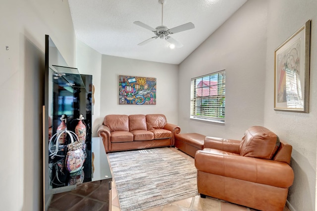 tiled living room with ceiling fan, lofted ceiling, and a textured ceiling