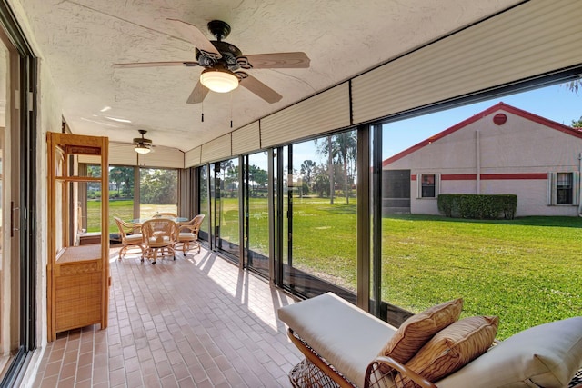 unfurnished sunroom featuring a wealth of natural light and ceiling fan