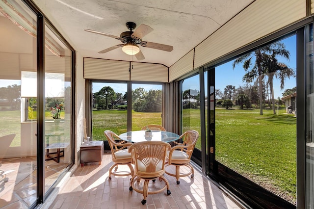 sunroom / solarium featuring ceiling fan