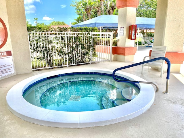 view of pool with a hot tub