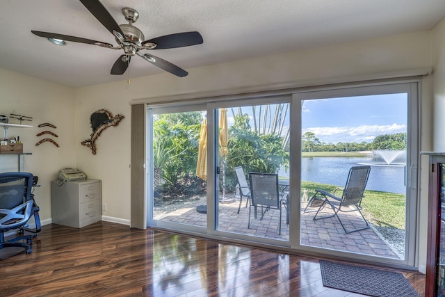 6938 Touchstone Cir, Palm Beach Gardens, FL 33418 - home office featuring a water view, wood finished floors, baseboards, ceiling fan, and a textured ceiling