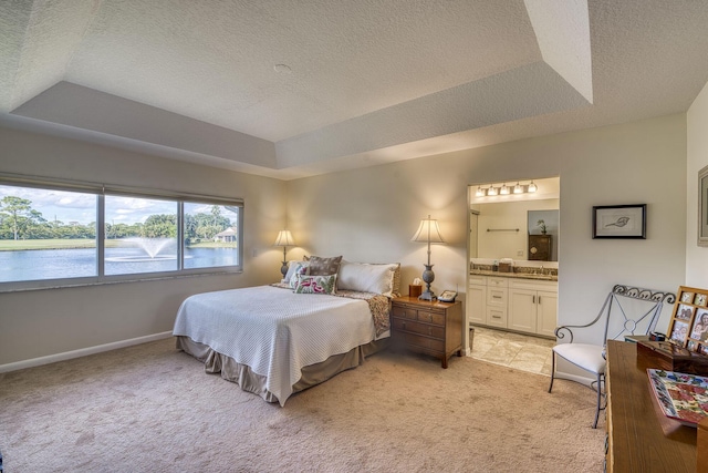 6938 Touchstone Cir, Palm Beach Gardens, FL 33418 - bedroom with a tray ceiling, light colored carpet, a textured ceiling, a water view, and connected bathroom