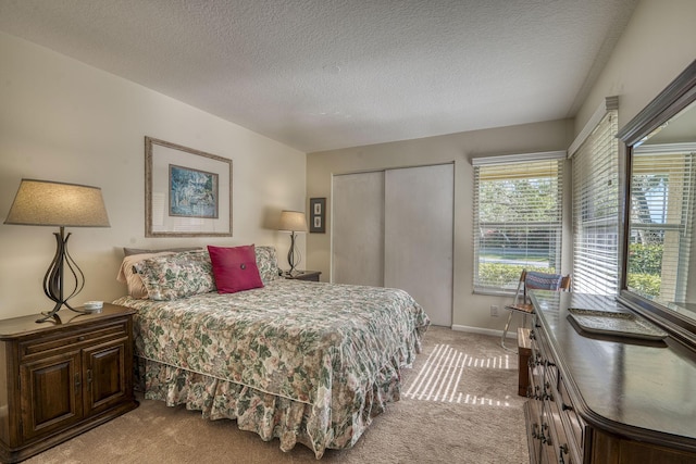 6938 Touchstone Cir, Palm Beach Gardens, FL 33418 - bedroom with light colored carpet, a closet, a textured ceiling, and baseboards